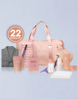 Collection of beauty products including a pink duffel bag, skincare items, and a robe on a light blue background.