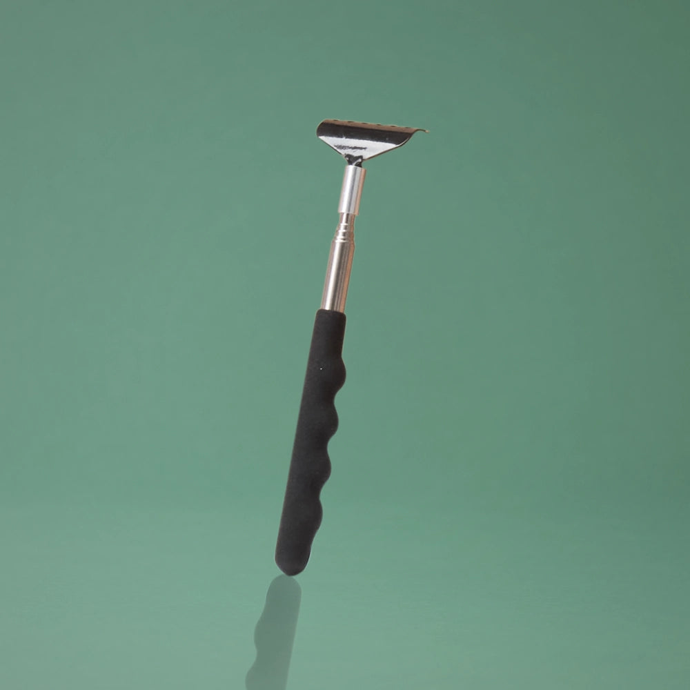 BeShapy Luxury BBL Recovery Kit Scraper tool with black handle and silver blade on a green background