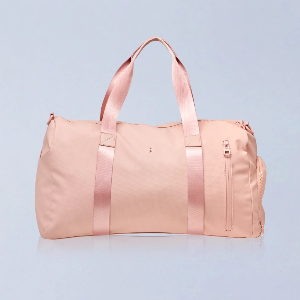 BeShapy Luxury BBL Recovery Kit healing essentials Pink duffel bag with satin straps on a light blue background