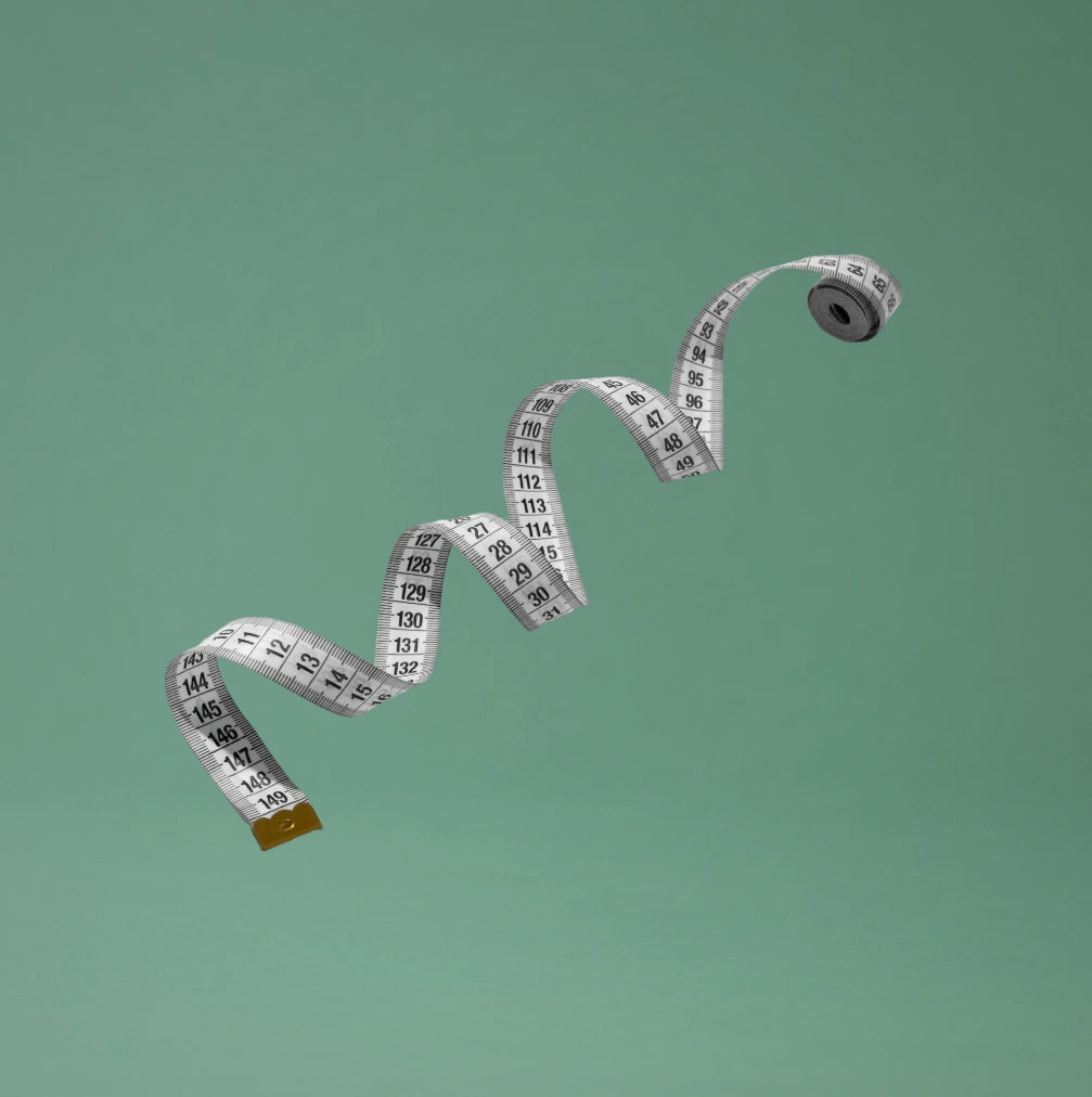 Measuring tape on a green background