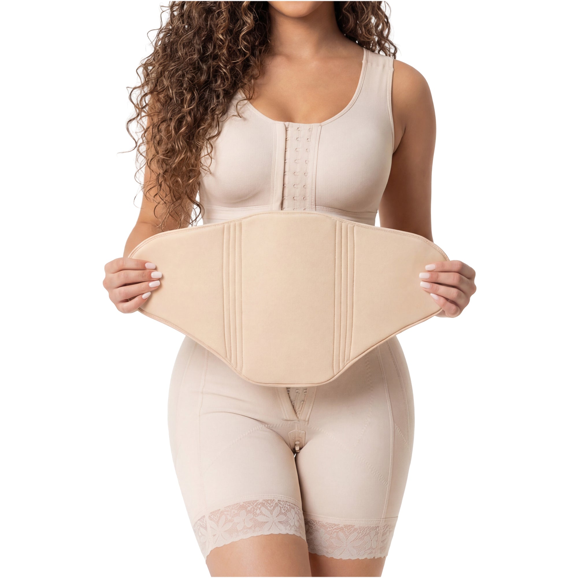 Woman resting comfortably during tummy tuck recovery wearing compression garment, ab board visible beneath faja
