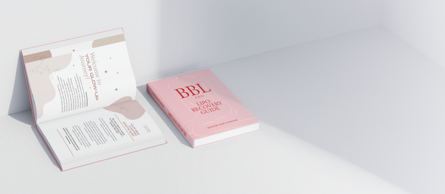 Pink book and open booklet on a white surface
