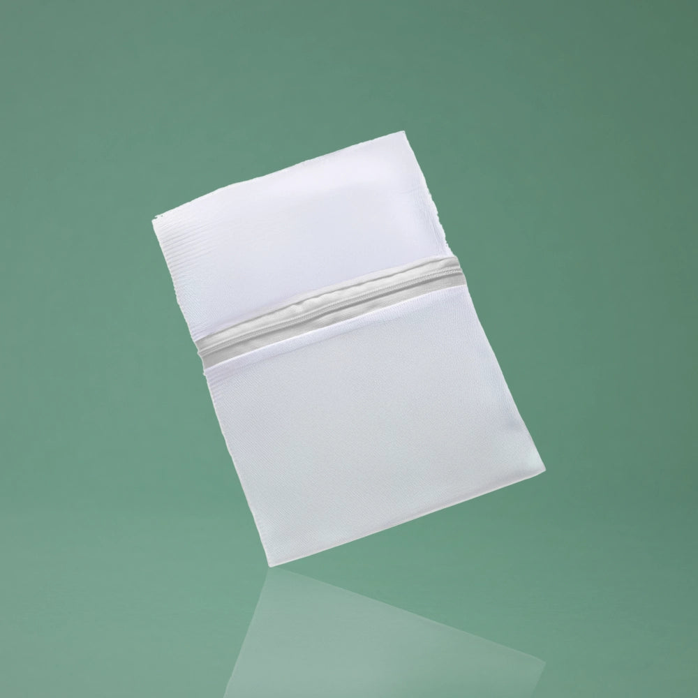 BeShapy Luxury BBL Recovery Kit  White washable bag with a zipper on a green background
